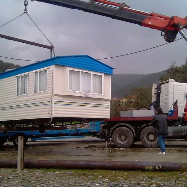 track crane lifting mobile home greece