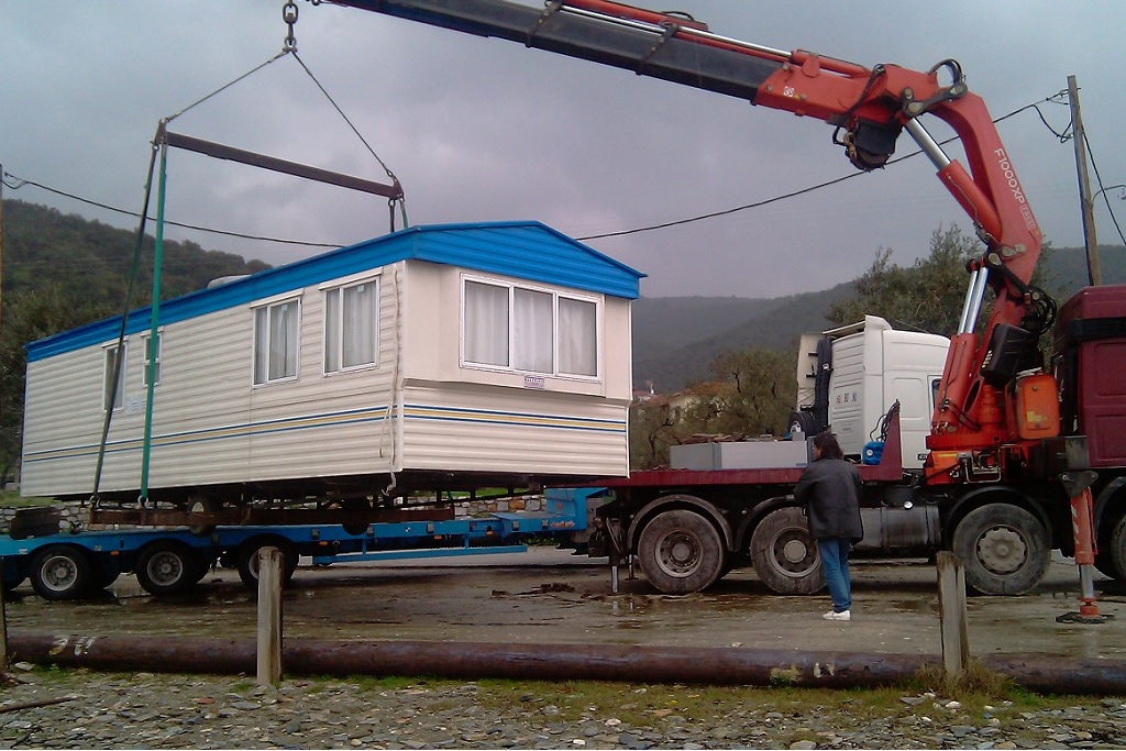 track crane lifting mobile home greece